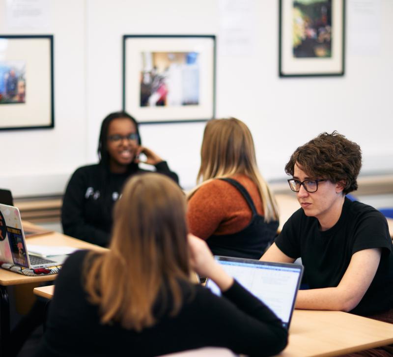 Four students in discussion at desks