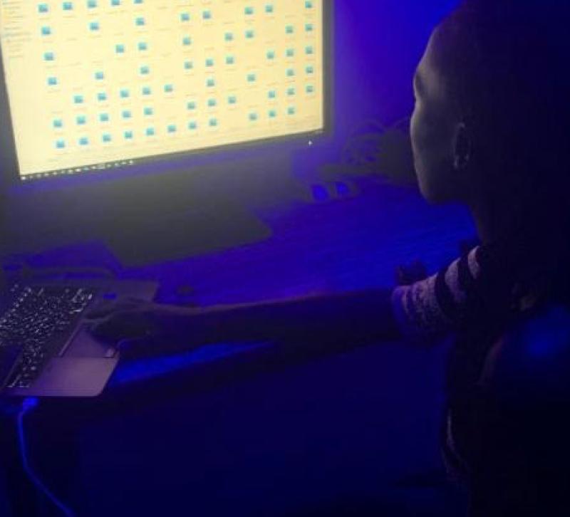 A women looking at screens against a blue background