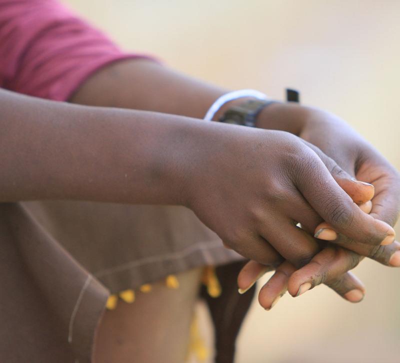 A young person's clasped hands