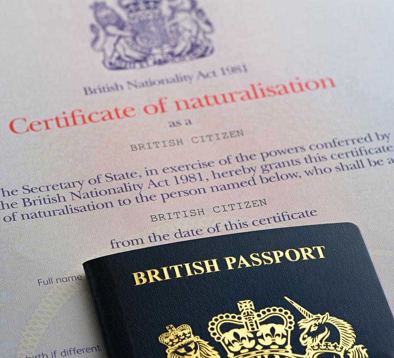 British Passport placed on top of certificate of naturalisation as a British Citizen
