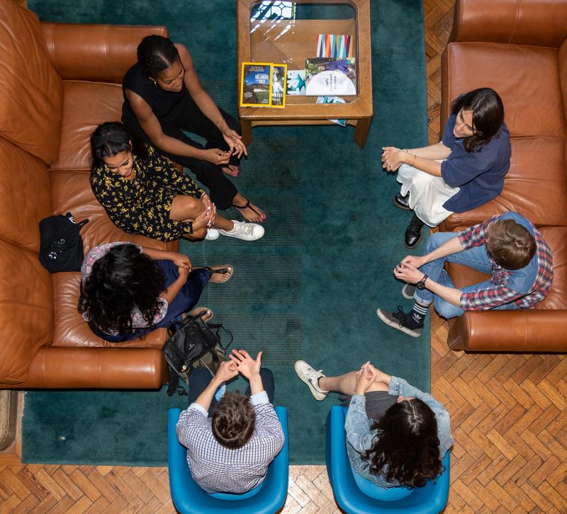 Aerial view of students sitting in the hall at Queen Elizabeth House