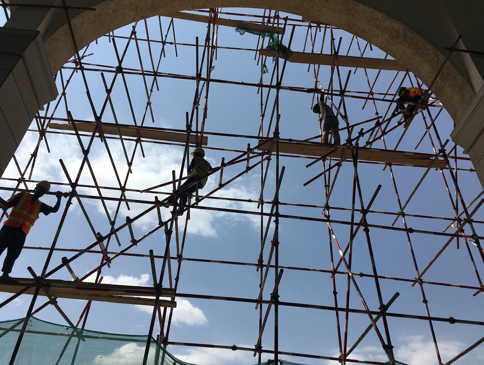 Workmen and scaffolding sihouetted against the sky at the Dire Dawa Railway Station, Ethiopia 