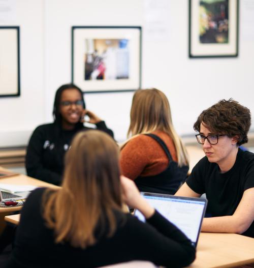Four students in discussion at desks