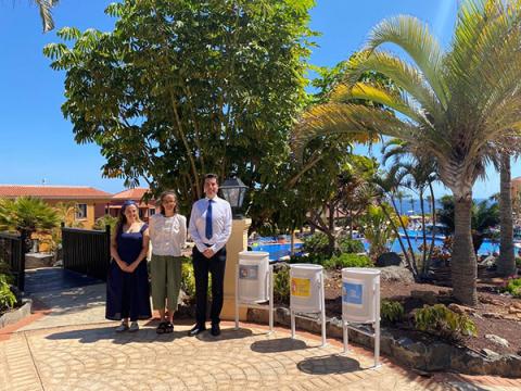Ruby-Ann Brin, Laura Ballerini and the hotel manager against a backdrop of palm trees