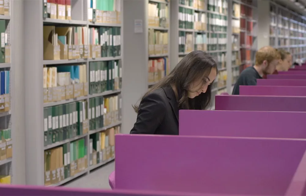 Students seated at desks in library