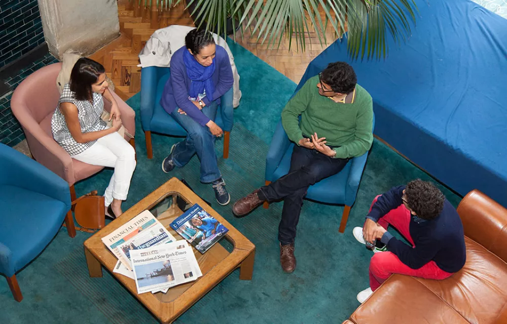 View from above of four people sitting in the Hall in the ODID building
