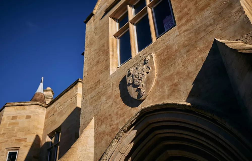 The golden stone of ODID's doorway against a bright blue sky