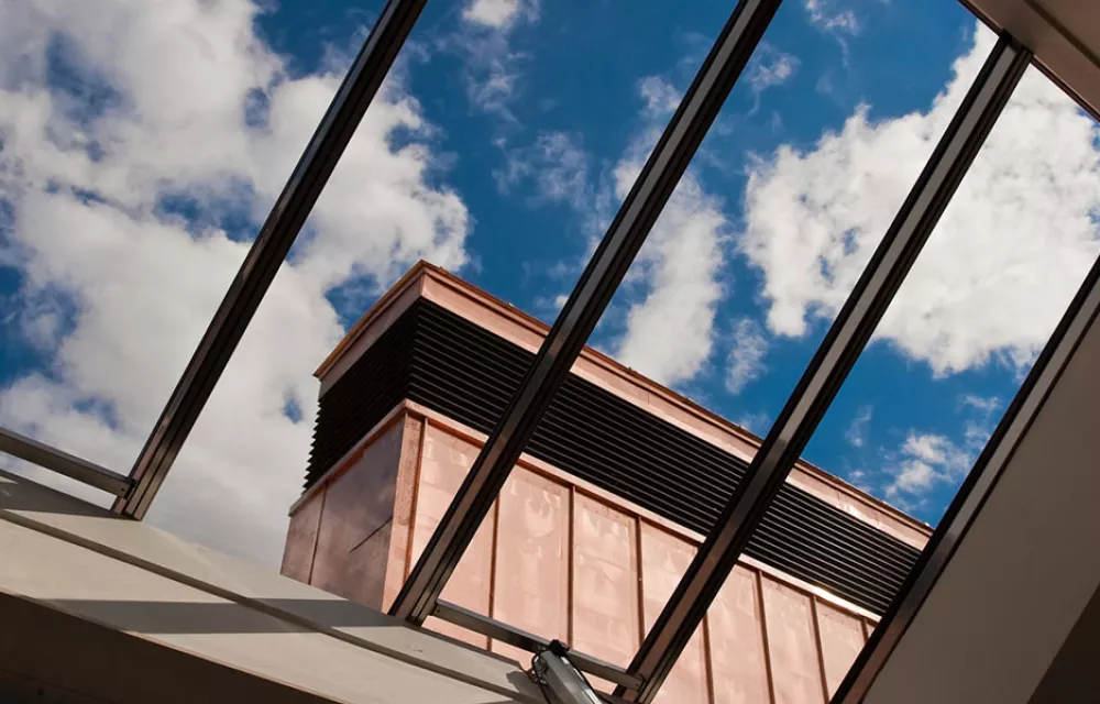 View through a skylight towards a bronze-clad structure on ODID's new building
