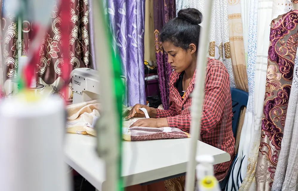 A young seamstress, photo taken as part of the Young Lives study