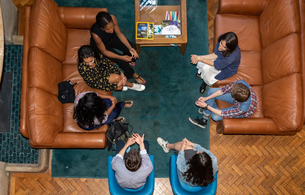 Aerial view of students sitting in the hall at Queen Elizabeth House