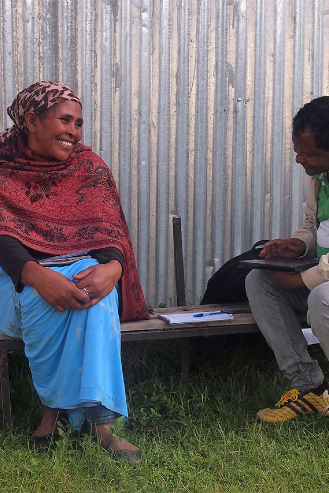 A man asking questions of a survey participant