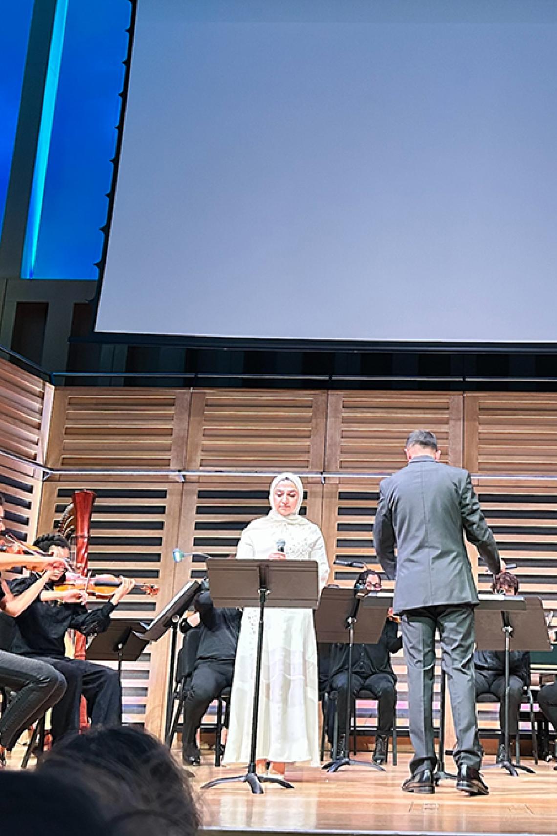 Hadia Azizi on stage with the Odyssey Ensemble