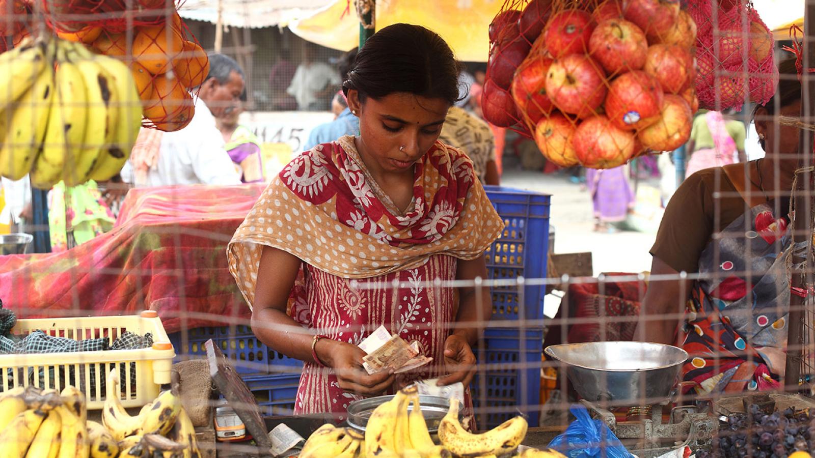 A young women shopping for fruit