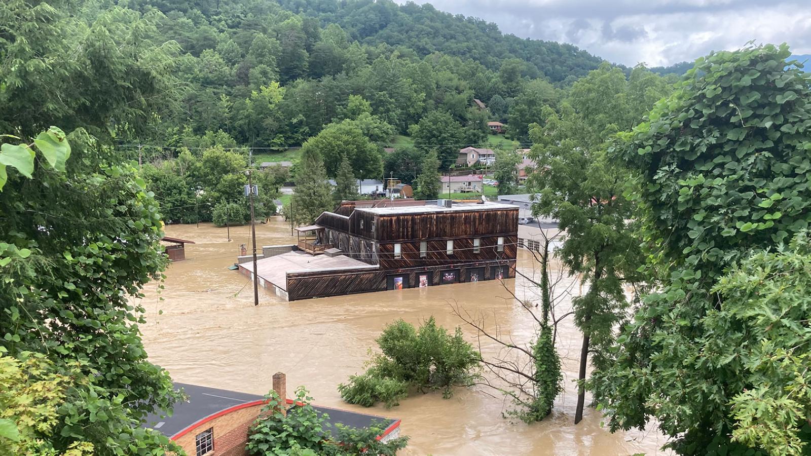 A factory building surrounded by floodwaters