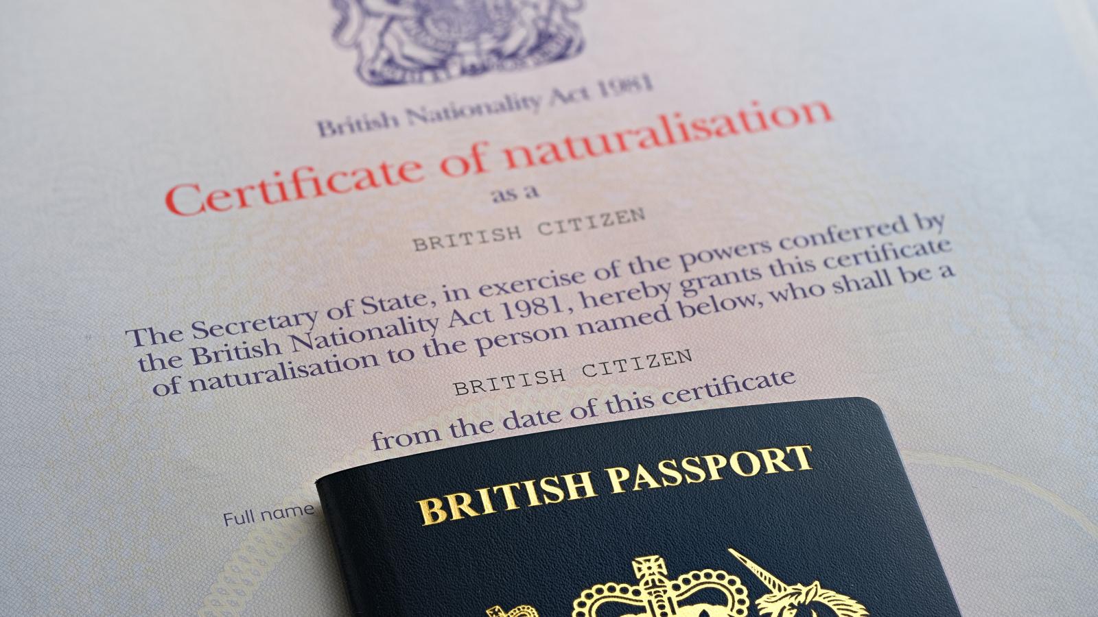 British Passport placed on top of certificate of naturalisation as a British Citizen