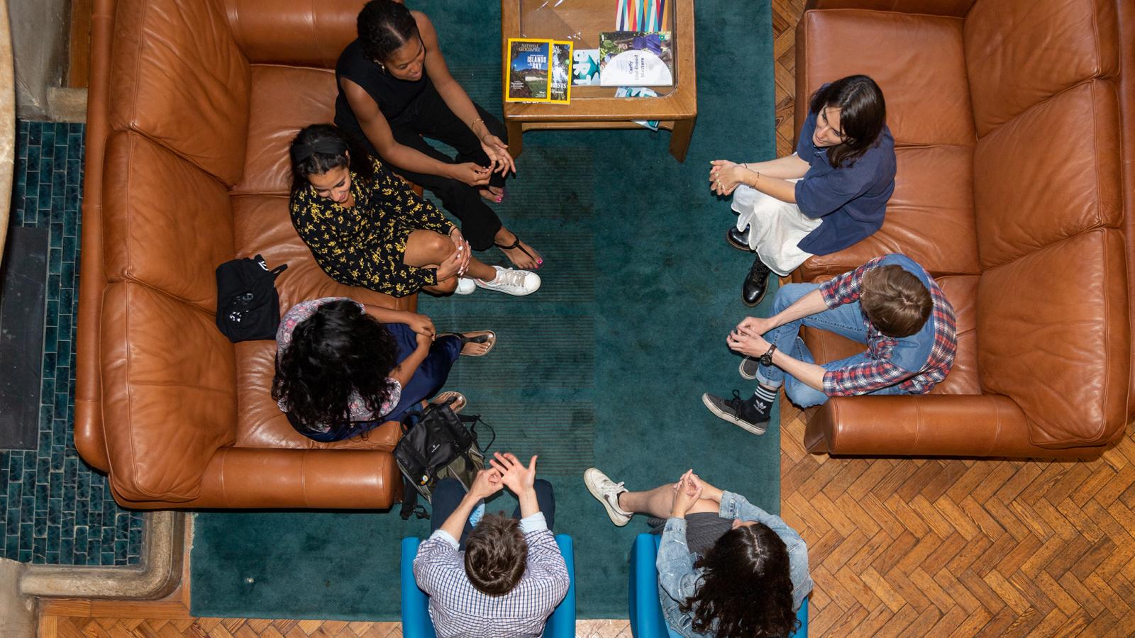 Aerial view of students sitting in the hall at Queen Elizabeth House